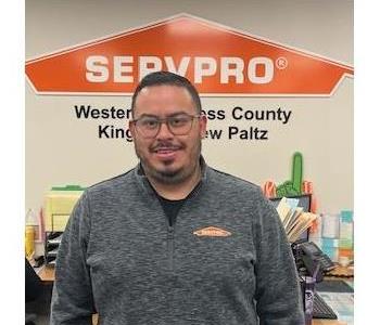 A photo of a smiling male employee wearing glasses in a SERVPRO® shirt.