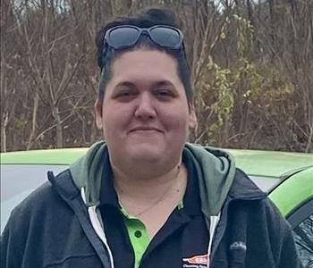 A smiling female employee wearing a black SERVPRO shirt.