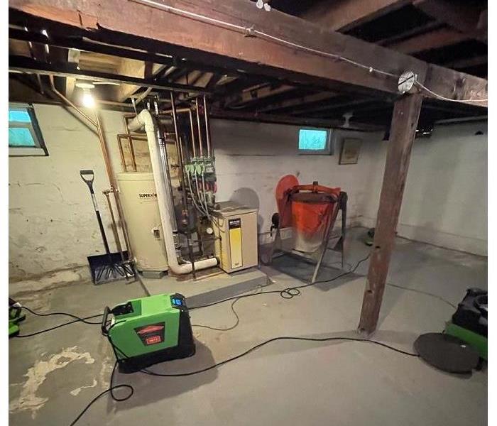 A basement of a home, empty of debris and contents and only having SERVPRO drying equipment in place