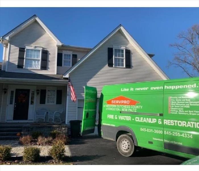 a green SERVPRO® truck parked in a home's driveway