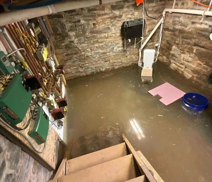 A rock-walled cellar flooded with about a foot of water from a recent storm.