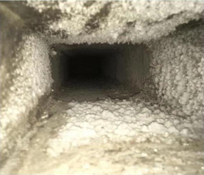 A heavily clogged section of air duct work in a home